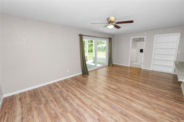 empty room with baseboards, light wood-style floors, and a ceiling fan