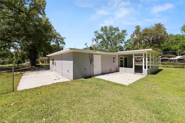 back of house featuring a yard and a patio area