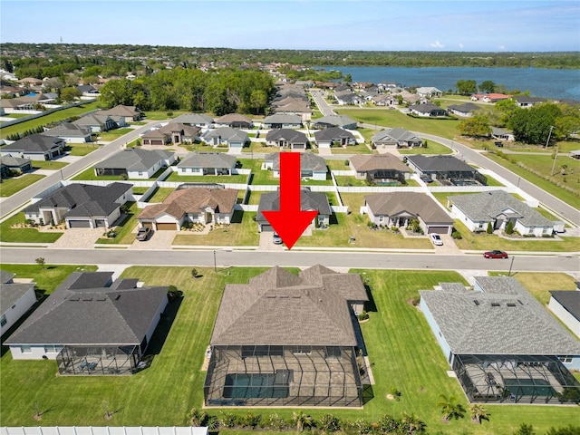 birds eye view of property with a residential view and a water view