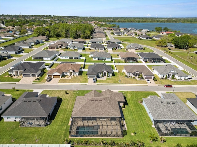 drone / aerial view featuring a residential view and a water view