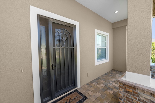 property entrance featuring stucco siding