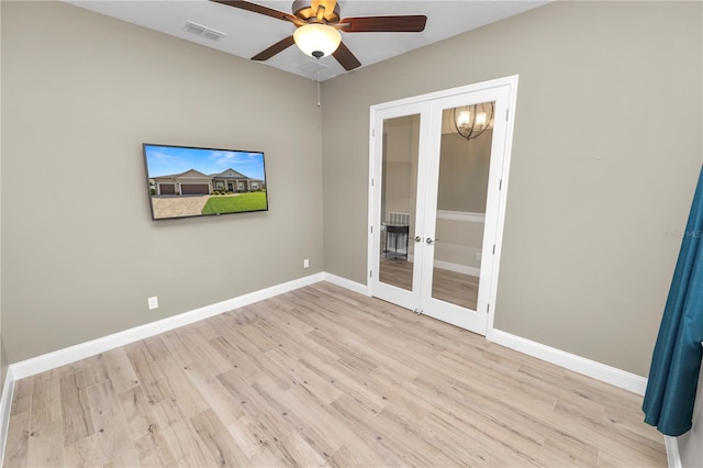 unfurnished room with french doors, baseboards, wood finished floors, and a ceiling fan