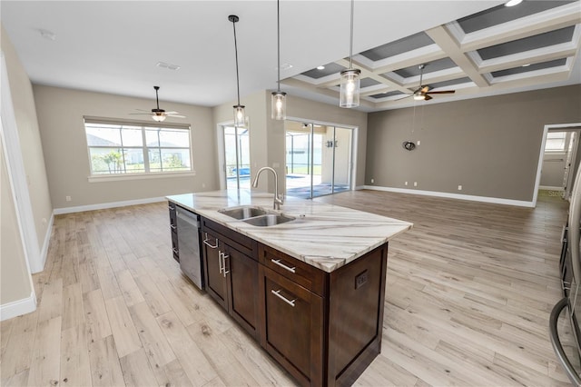 kitchen with a sink, open floor plan, stainless steel dishwasher, and ceiling fan