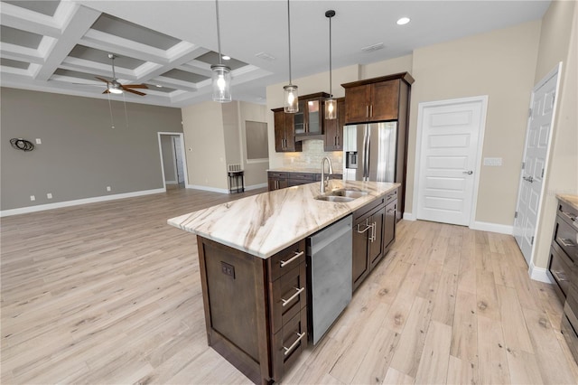 kitchen with coffered ceiling, a sink, ceiling fan, stainless steel appliances, and tasteful backsplash