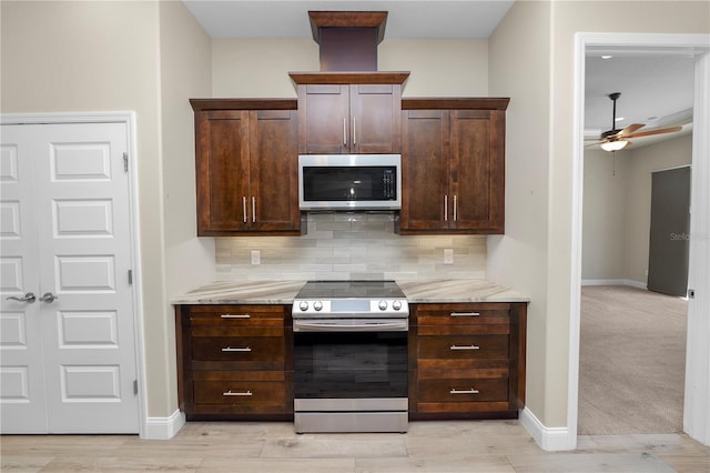 kitchen featuring stainless steel appliances, tasteful backsplash, dark brown cabinetry, and a ceiling fan