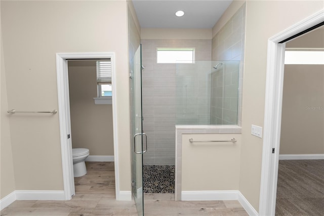 full bath featuring baseboards, toilet, and a stall shower