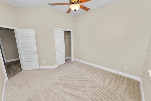 unfurnished bedroom with visible vents, ceiling fan, baseboards, carpet, and a closet