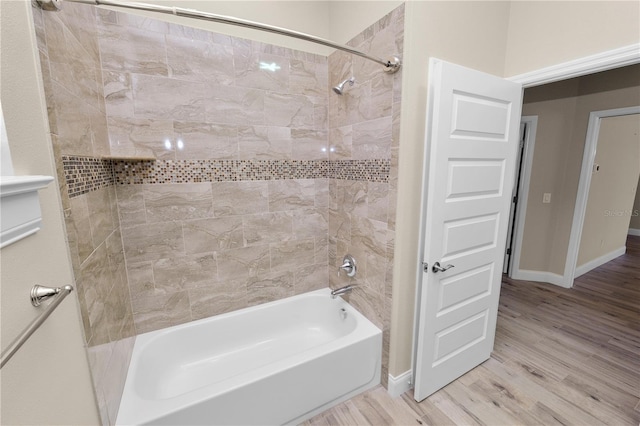 bathroom featuring shower / bath combination, baseboards, and wood finished floors