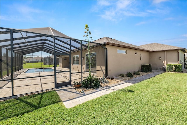 view of side of property with a lanai, stucco siding, a lawn, an outdoor pool, and a patio