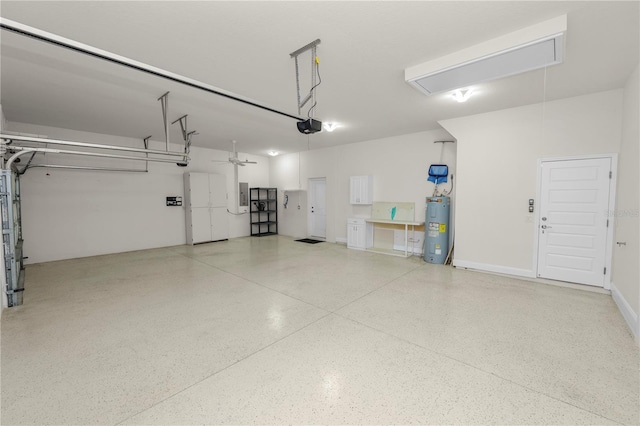 garage featuring electric panel, a garage door opener, and water heater