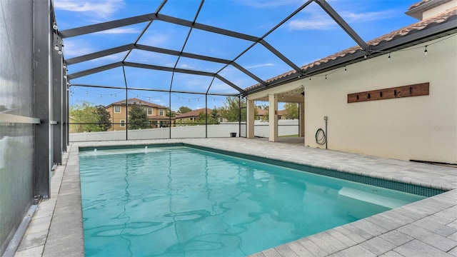 view of pool featuring glass enclosure, a patio, and a fenced in pool