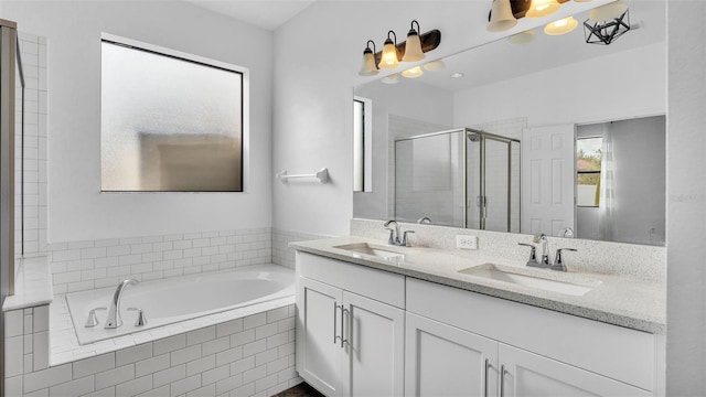 full bathroom featuring a garden tub, double vanity, a stall shower, and a sink