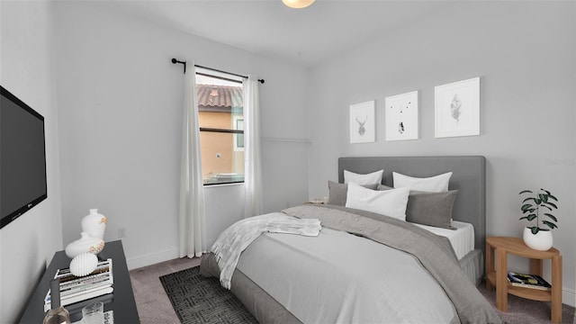 bedroom featuring baseboards and carpet floors