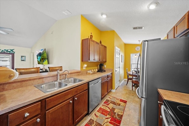 kitchen featuring a sink, visible vents, appliances with stainless steel finishes, and light countertops