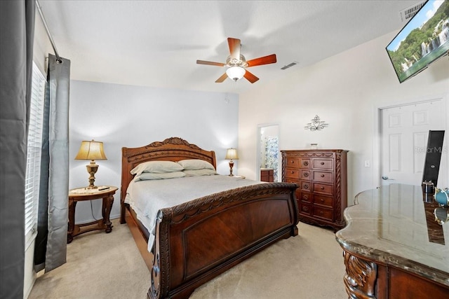 bedroom with visible vents, light carpet, and ceiling fan