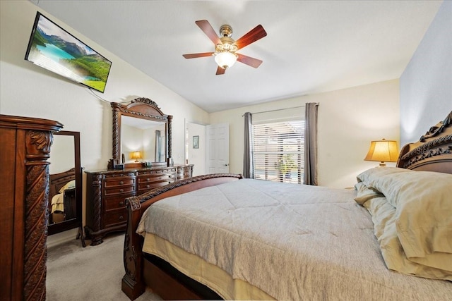 bedroom featuring light carpet, ceiling fan, and vaulted ceiling