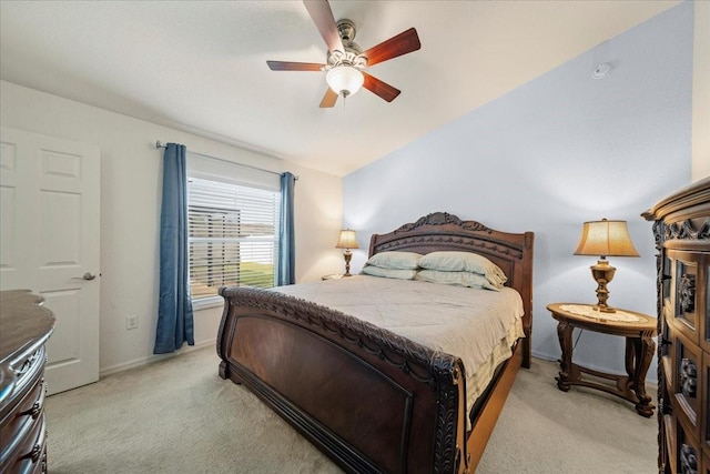 bedroom featuring light carpet, baseboards, a ceiling fan, and lofted ceiling