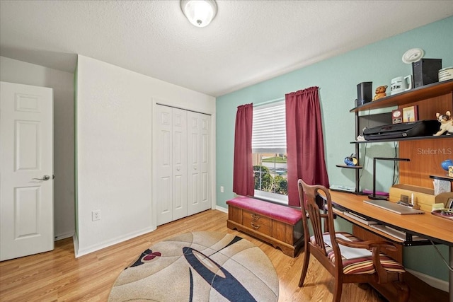 home office with wood finished floors, baseboards, and a textured ceiling