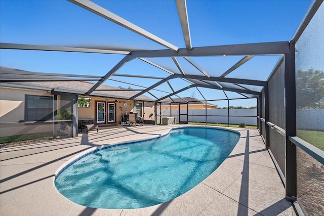 view of swimming pool with a fenced in pool, a patio, a lanai, and french doors