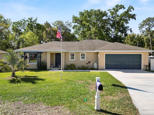 ranch-style home with concrete driveway, an attached garage, a front yard, and stucco siding