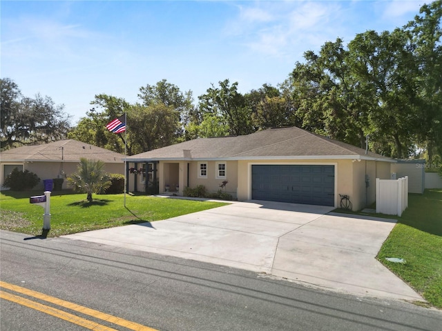 ranch-style home with a front yard, an attached garage, a shingled roof, stucco siding, and concrete driveway