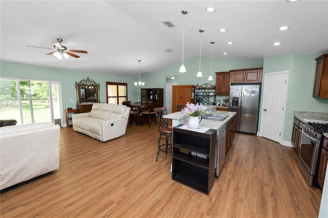 kitchen with open floor plan, visible vents, appliances with stainless steel finishes, and ceiling fan