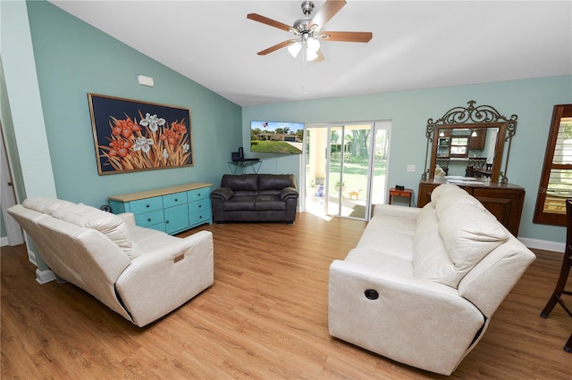 living area with vaulted ceiling, baseboards, light wood finished floors, and ceiling fan