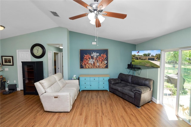 living room featuring light wood finished floors, visible vents, baseboards, vaulted ceiling, and a ceiling fan