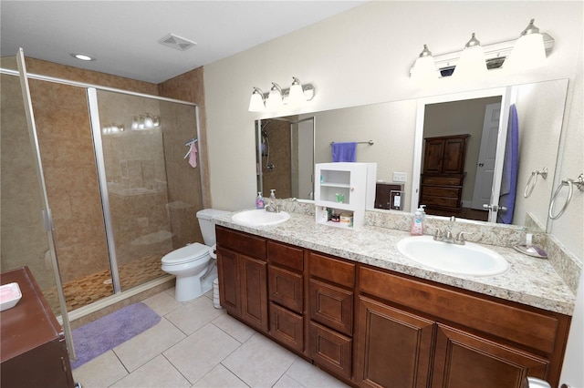 bathroom featuring visible vents, a shower stall, and a sink