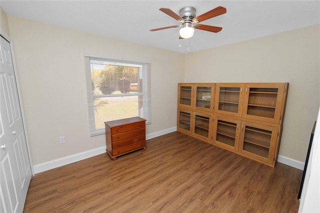 bedroom with a closet, a ceiling fan, light wood-type flooring, and baseboards