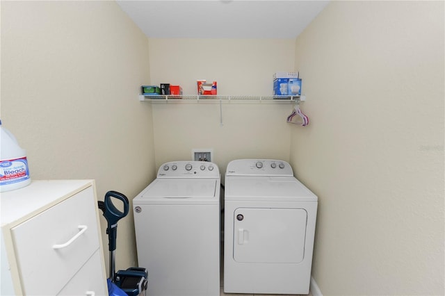 clothes washing area featuring laundry area and separate washer and dryer