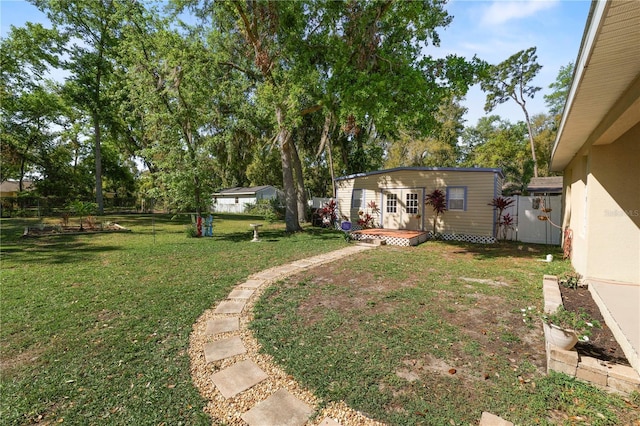 view of yard with an outbuilding and fence