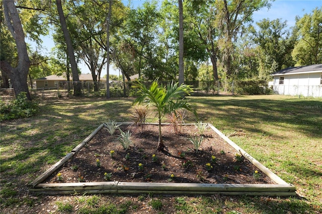 view of yard with fence and a garden