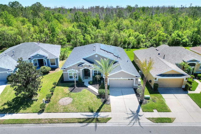 drone / aerial view with a wooded view