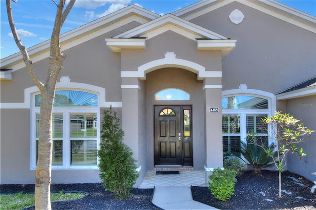 entrance to property with stucco siding