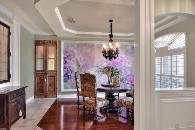 dining room with visible vents, an inviting chandelier, light tile patterned flooring, crown molding, and a raised ceiling