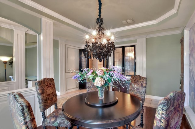 dining room featuring visible vents, light tile patterned flooring, crown molding, a raised ceiling, and a chandelier