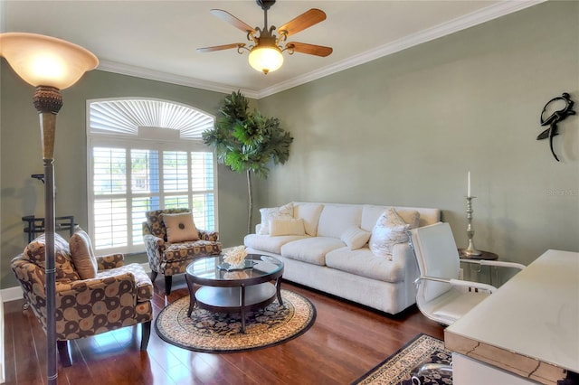 living area with wood finished floors, ornamental molding, and a ceiling fan