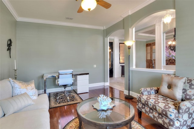 living room featuring visible vents, arched walkways, wood finished floors, and ornamental molding