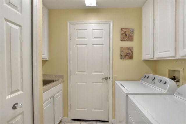 laundry room with a sink, cabinet space, and washer and clothes dryer