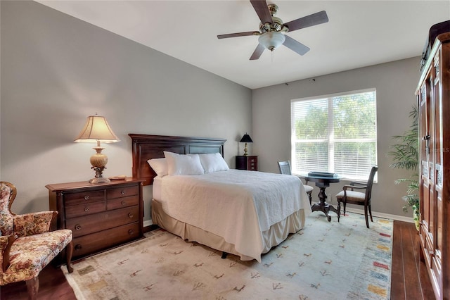 bedroom featuring light wood-type flooring, baseboards, and ceiling fan