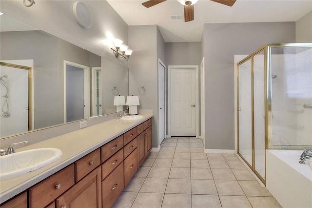 bathroom featuring tile patterned flooring, a stall shower, and a sink