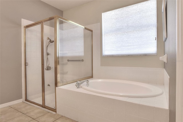 bathroom with tile patterned floors, a garden tub, and a stall shower