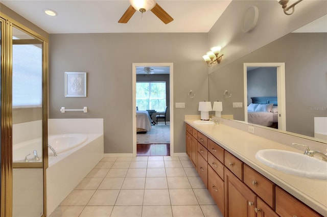 full bathroom featuring a garden tub, double vanity, ensuite bathroom, tile patterned floors, and a sink