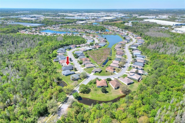 aerial view with a wooded view and a water view