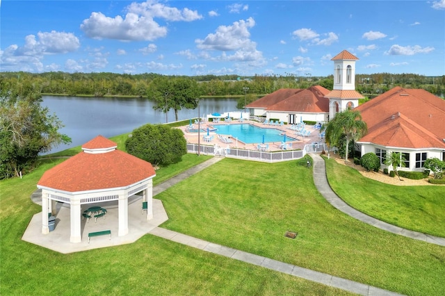 pool with a gazebo, a yard, a water view, and a patio area