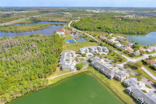 birds eye view of property with a forest view, a water view, and a residential view