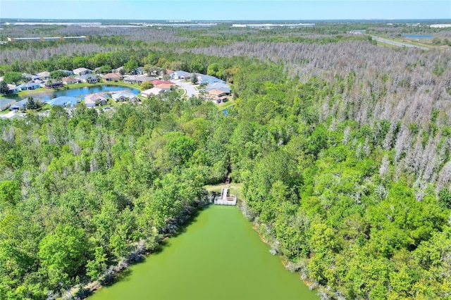 aerial view with a forest view and a water view