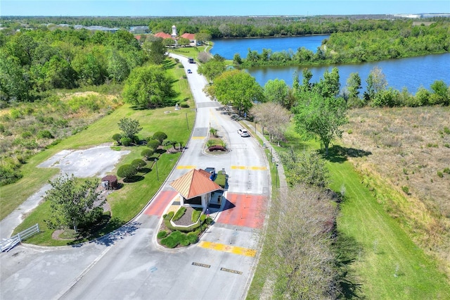 drone / aerial view featuring a forest view and a water view