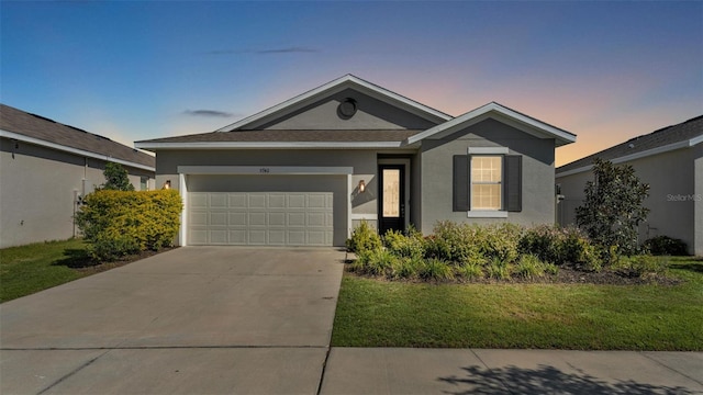 ranch-style house featuring stucco siding, an attached garage, driveway, and a lawn